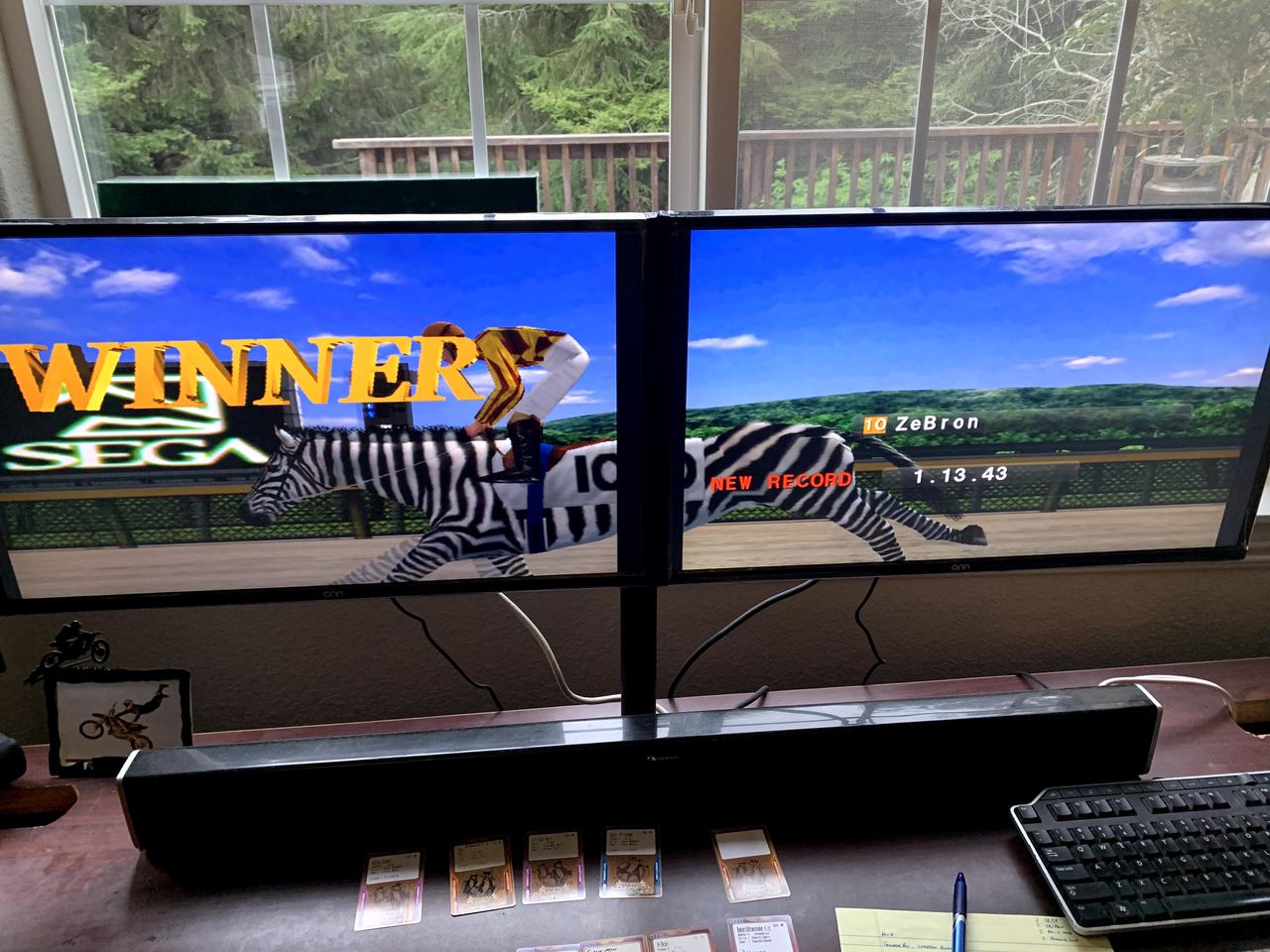 The two-screen race board showing a zebra-coated horse winning with a new track record.