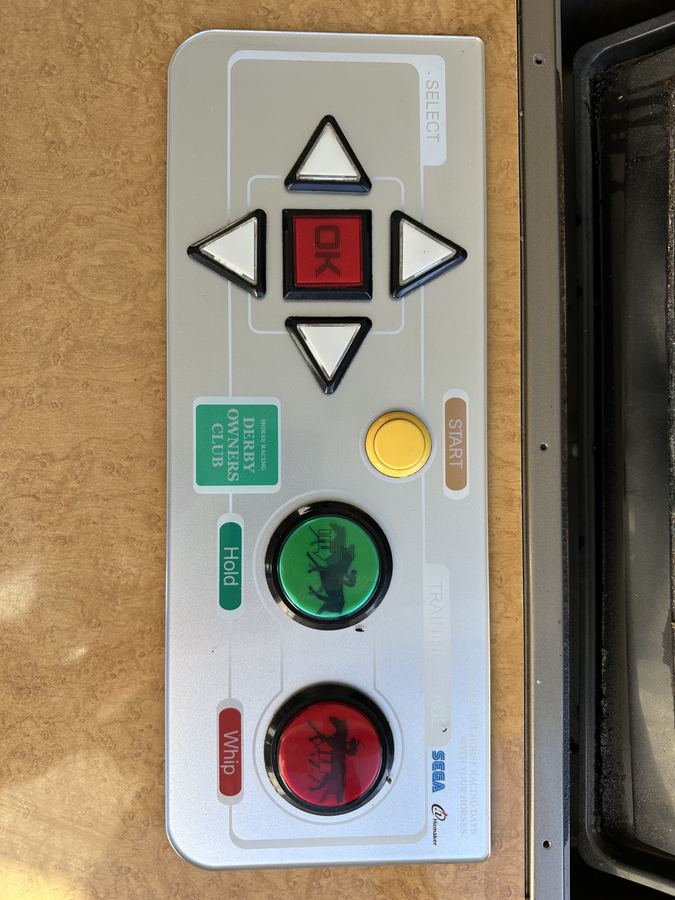 A white Derby Owners Club control panel with direction plate and buttons.
