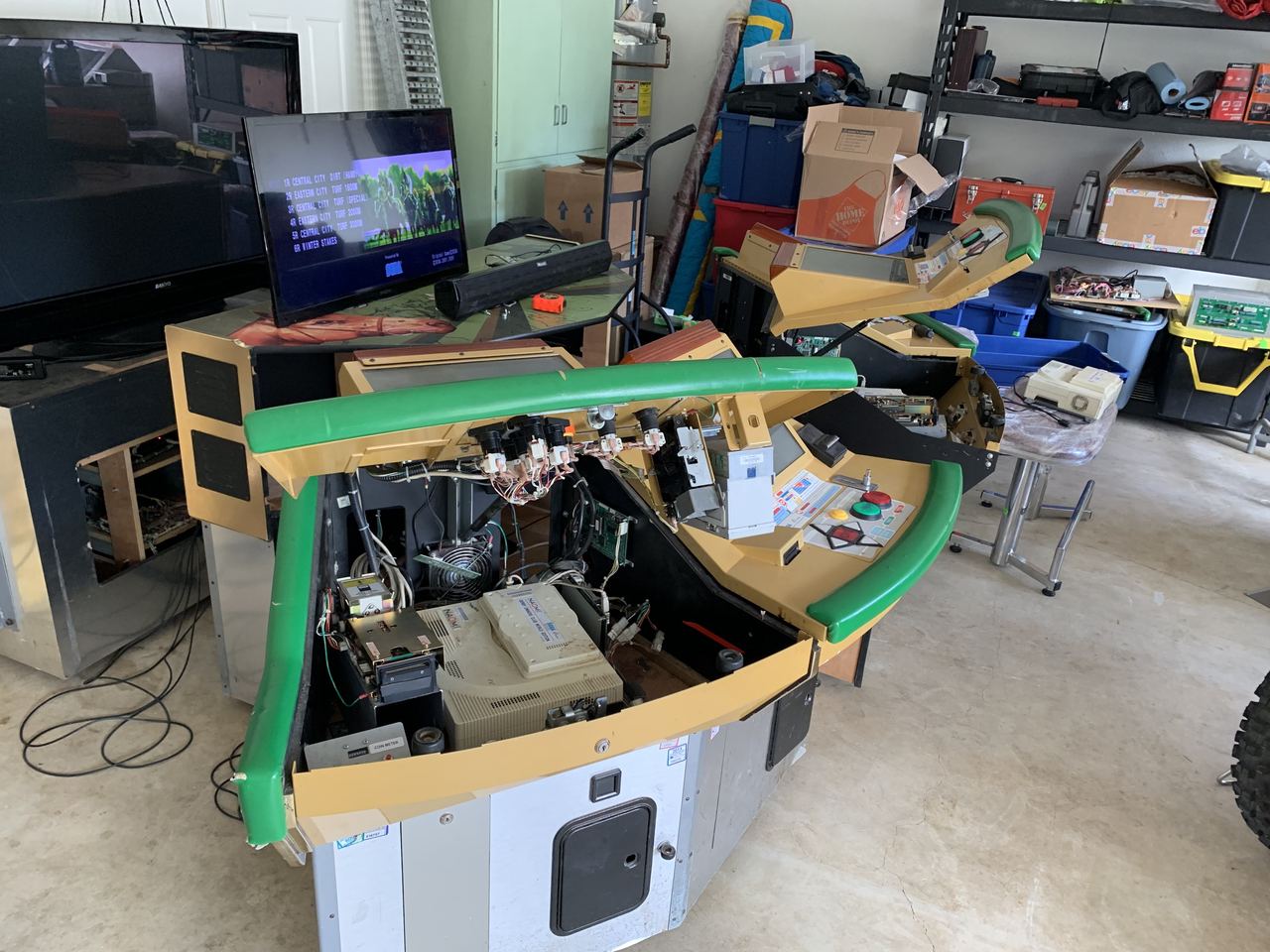A satellite seat opened up showing its monitor, boards and wiring.
