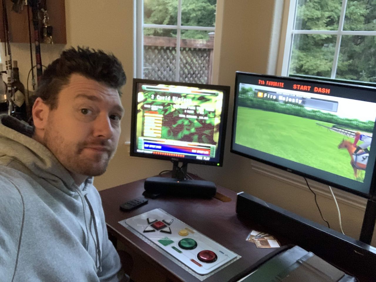 A player at a Derby Owners Club seat with the game running on two screens.